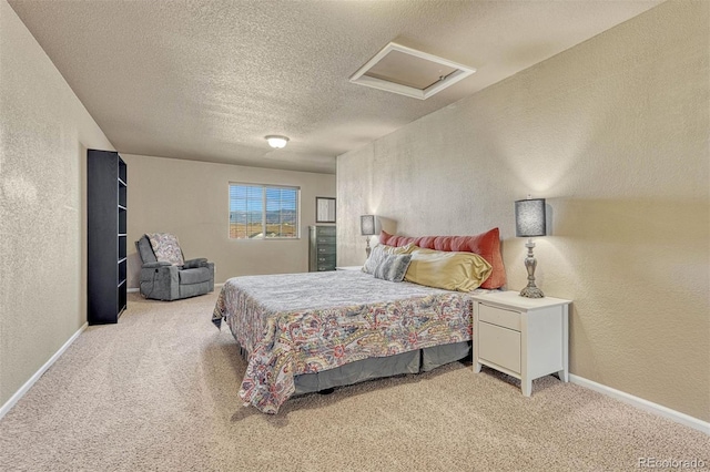 7963 Bonfire Trl, Fountain, CO 80817 - bedroom with a textured wall, attic access, light carpet, a textured ceiling, and baseboards