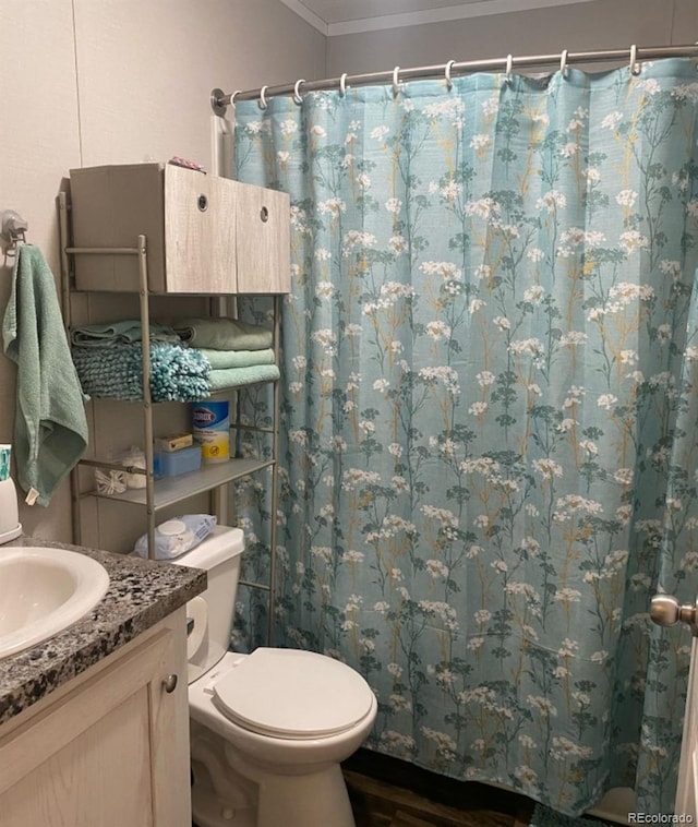 431 N 35th Ave Unit 51, Greeley, CO 80631 - full bathroom featuring vanity, toilet, curtained shower, wood finished floors, and ornamental molding