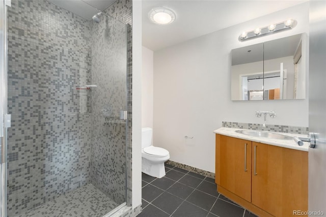 full bathroom featuring toilet, tile patterned flooring, vanity, and a shower stall