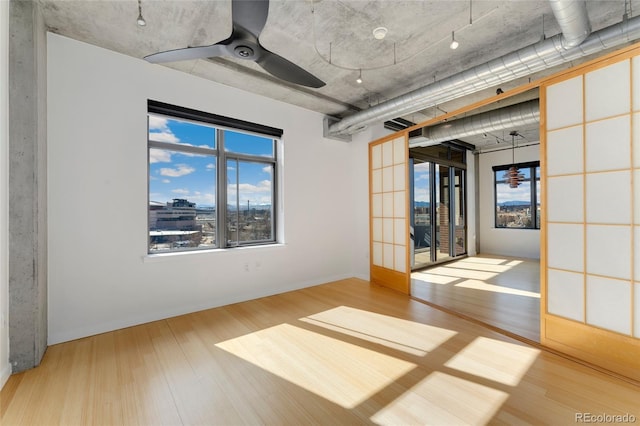 empty room featuring a ceiling fan and wood finished floors