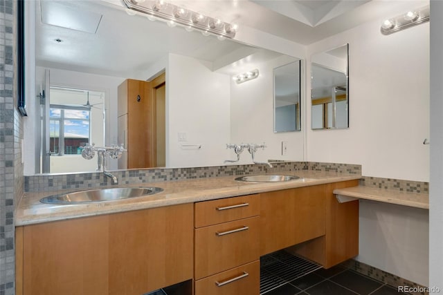 full bath with double vanity, tile patterned flooring, a sink, and decorative backsplash