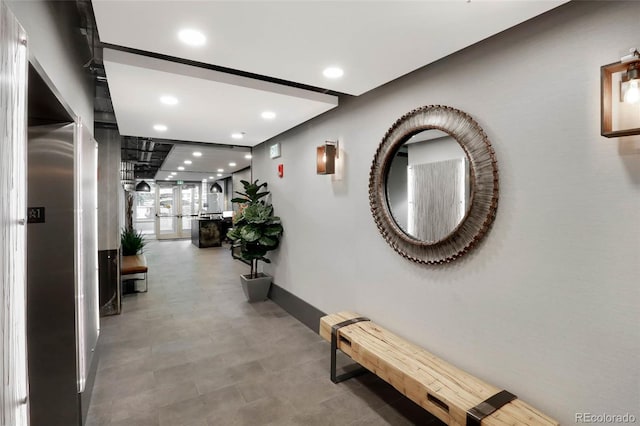 hall featuring baseboards and recessed lighting