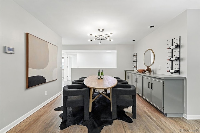 11 S Albion St, Denver, CO 80246 - dining area featuring light wood-style floors, a chandelier, and baseboards