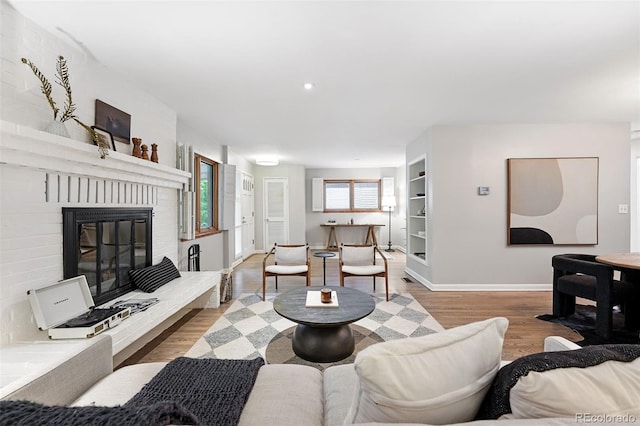 11 S Albion St, Denver, CO 80246 - living room featuring wood finished floors, baseboards, and a brick fireplace