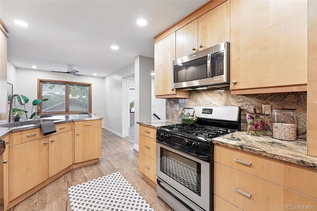 11 S Albion St, Denver, CO 80246 - kitchen with stainless steel appliances, light brown cabinetry, light wood finished floors, backsplash, and recessed lighting