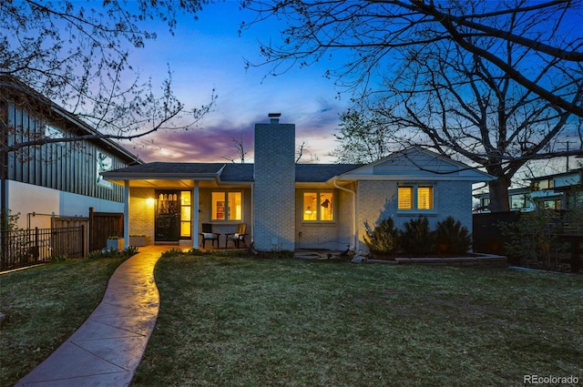 11 S Albion St, Denver, CO 80246 - back of property at dusk featuring a chimney and brick siding