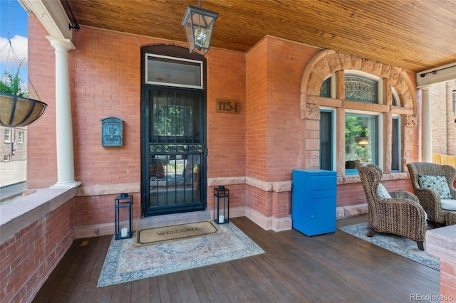 1154 N Clarkson St, Denver, CO 80218 - doorway to property with covered porch and brick siding