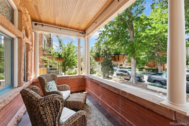 1154 N Clarkson St, Denver, CO 80218 - sunroom featuring ornate columns, wooden ceiling, and wood-type flooring