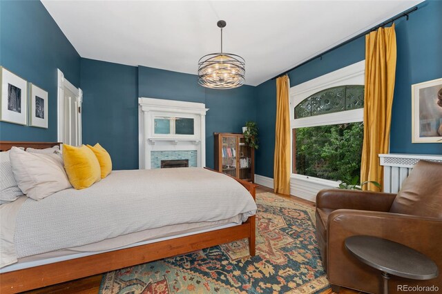 1154 N Clarkson St, Denver, CO 80218 - bedroom with wood finished floors, a chandelier, and a fireplace