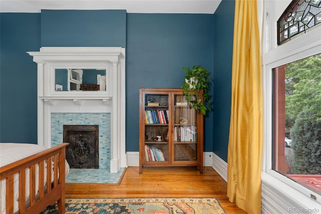 1154 N Clarkson St, Denver, CO 80218 - bedroom with wood finished floors and a tile fireplace