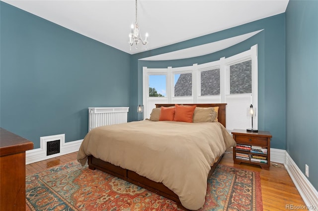 1154 N Clarkson St, Denver, CO 80218 - bedroom with a chandelier and wood finished floors