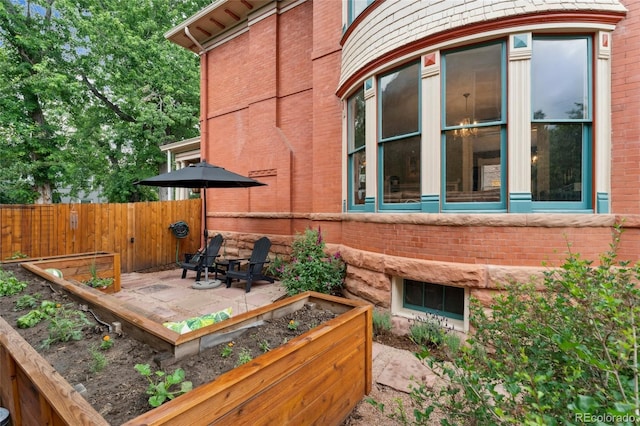 1154 N Clarkson St, Denver, CO 80218 - view of side of home featuring brick siding and a garden