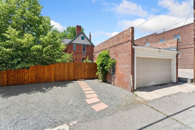 1154 N Clarkson St, Denver, CO 80218 - view of property exterior with brick siding, a garage, and concrete driveway