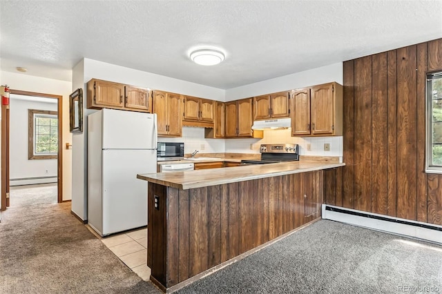 675 Straight Creek Dr Unit 301, Dillon, CO 80435 - kitchen with light carpet, appliances with stainless steel finishes, a baseboard radiator, a peninsula, and a textured ceiling