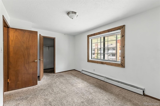 675 Straight Creek Dr Unit 301, Dillon, CO 80435 - unfurnished bedroom with a baseboard heating unit, light carpet, and a textured ceiling