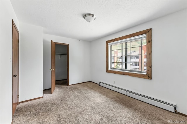 675 Straight Creek Dr Unit 301, Dillon, CO 80435 - unfurnished bedroom featuring light colored carpet, a baseboard heating unit, and a textured ceiling