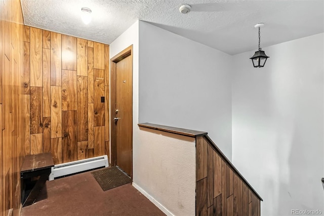 675 Straight Creek Dr Unit 301, Dillon, CO 80435 - corridor with carpet, a baseboard heating unit, and a textured ceiling