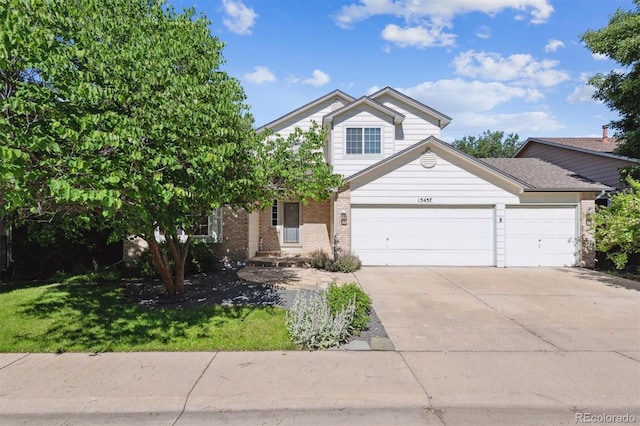 13457 Glen Cir, Broomfield, CO 80020 - view of front facade with an attached garage, driveway, brick siding, and a front lawn