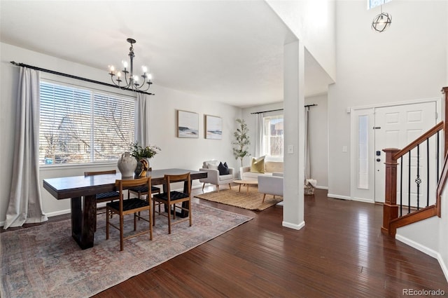 dining room with dark hardwood / wood-style flooring and a notable chandelier