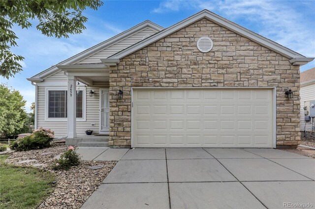 2659 S Halifax St, Aurora, CO 80013 - view of front of property with stone siding, driveway, and an attached garage