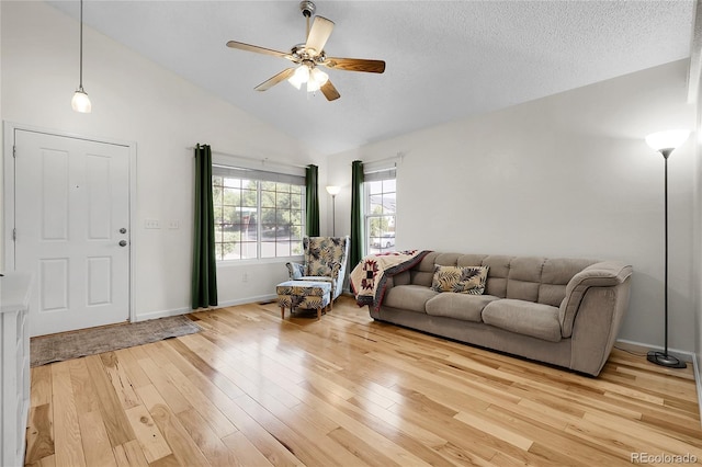 2659 S Halifax St, Aurora, CO 80013 - living room featuring lofted ceiling, light wood-style flooring, a ceiling fan, and a textured ceiling