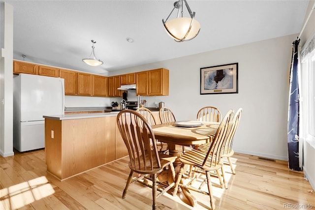 2659 S Halifax St, Aurora, CO 80013 - dining room with light wood-style floors and baseboards