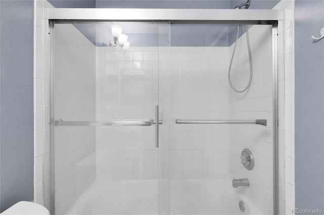 2659 S Halifax St, Aurora, CO 80013 - bathroom featuring shower / bath combination with glass door and toilet