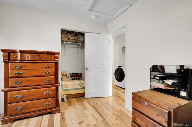 2659 S Halifax St, Aurora, CO 80013 - bedroom featuring washer / clothes dryer, light wood-style flooring, attic access, and a closet