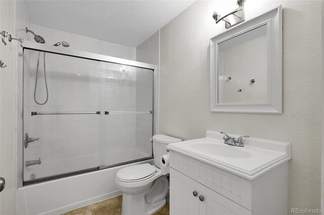 2659 S Halifax St, Aurora, CO 80013 - bathroom with vanity, bath / shower combo with glass door, a textured ceiling, and a textured wall