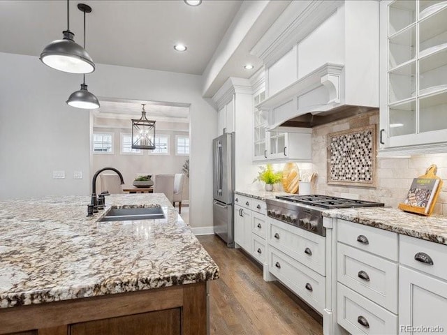 kitchen with sink, white cabinets, pendant lighting, and appliances with stainless steel finishes