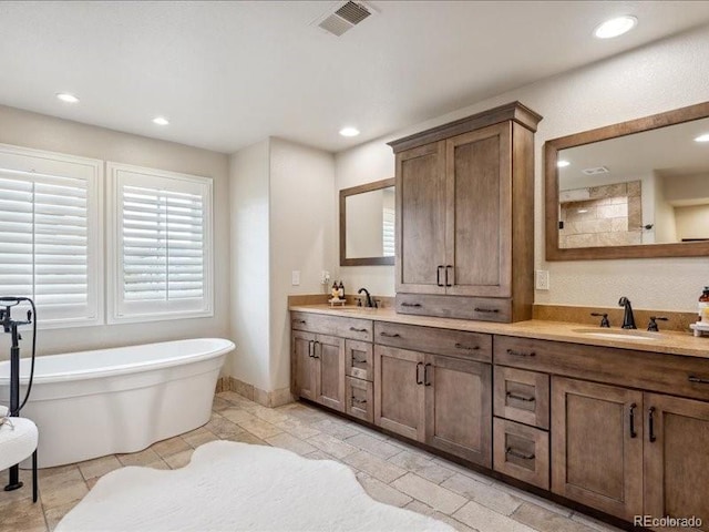 bathroom featuring vanity and a bathing tub