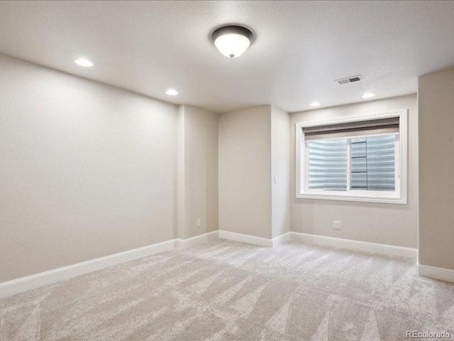 unfurnished room featuring light colored carpet