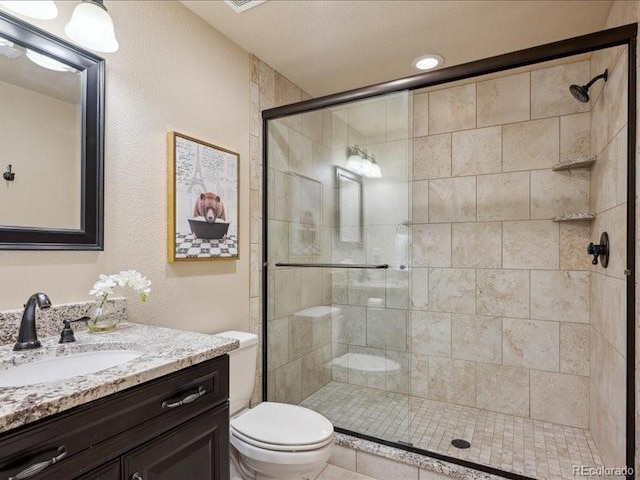 bathroom featuring vanity, toilet, and an enclosed shower