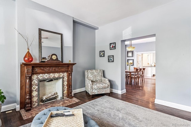 sitting room featuring dark hardwood / wood-style floors and a tile fireplace