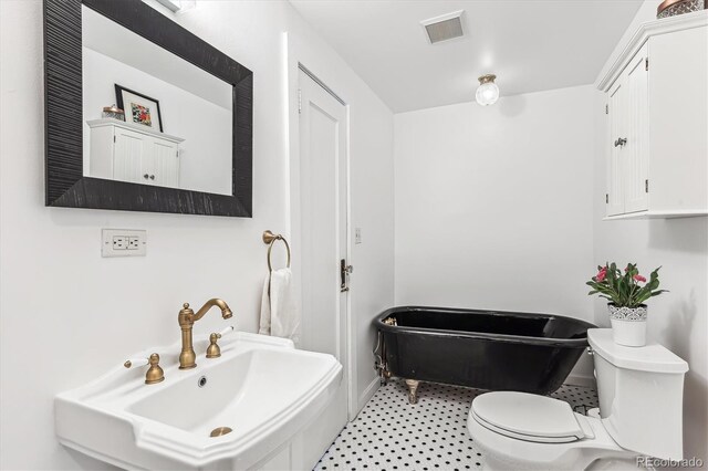 bathroom with toilet, sink, and a bath