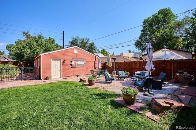 view of yard with a patio, a fire pit, and an outdoor structure