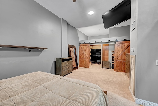 carpeted bedroom featuring ceiling fan, a barn door, and high vaulted ceiling