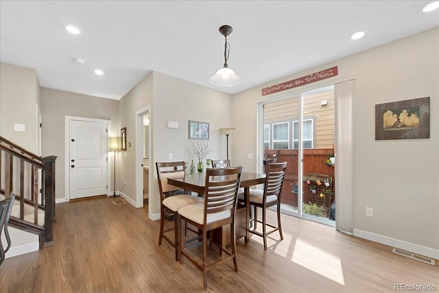 dining space with hardwood / wood-style flooring