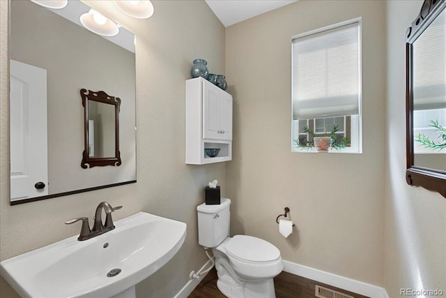 bathroom featuring sink, hardwood / wood-style floors, and toilet