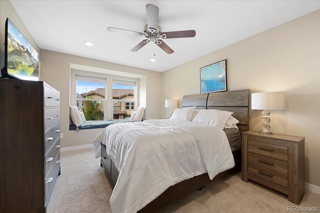 bedroom featuring ceiling fan and light carpet