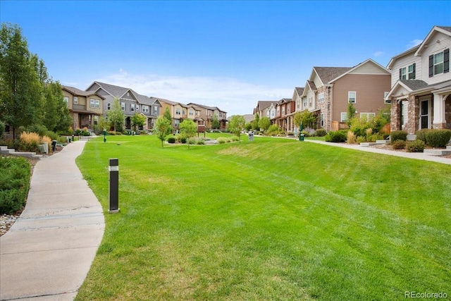 view of property's community featuring a yard