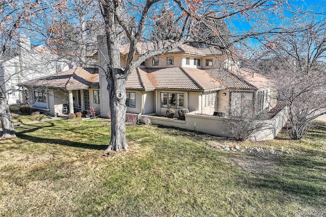 rear view of house featuring a lawn