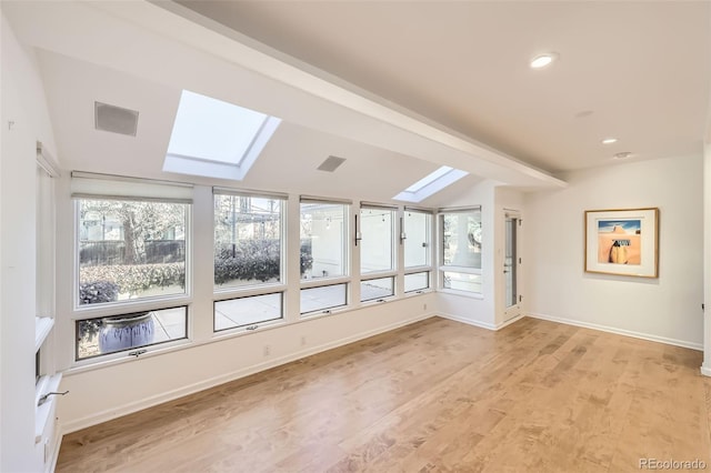 bonus room with light hardwood / wood-style floors and lofted ceiling with skylight