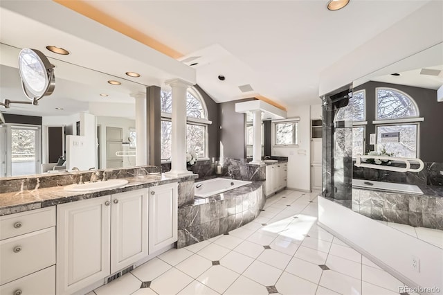 bathroom with tile patterned flooring, vanity, ornate columns, and lofted ceiling