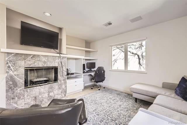 living room featuring a tiled fireplace