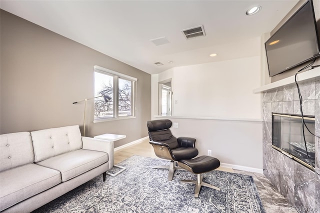 living room with a tile fireplace