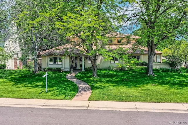 2 Elm St, Denver, CO 80220 - view of front of home with stucco siding, a front yard, and a tiled roof