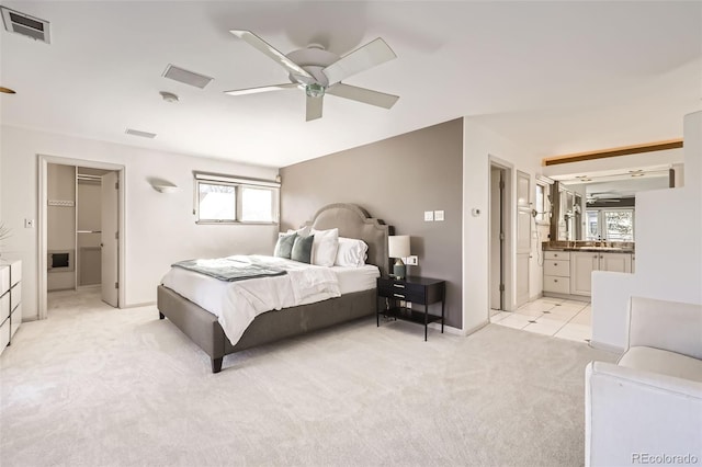 2 Elm St, Denver, CO 80220 - bedroom with light carpet, a sink, baseboards, connected bathroom, and a ceiling fan