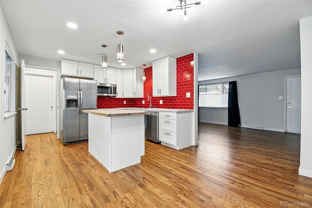 6948 W 70th Ave, Arvada, CO 80003 - kitchen featuring visible vents, light countertops, white cabinetry, and stainless steel appliances
