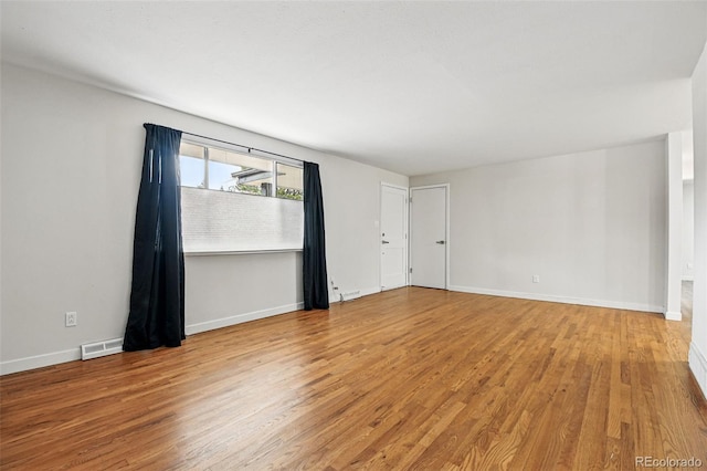 6948 W 70th Ave, Arvada, CO 80003 - unfurnished room featuring baseboards, wood finished floors, and visible vents